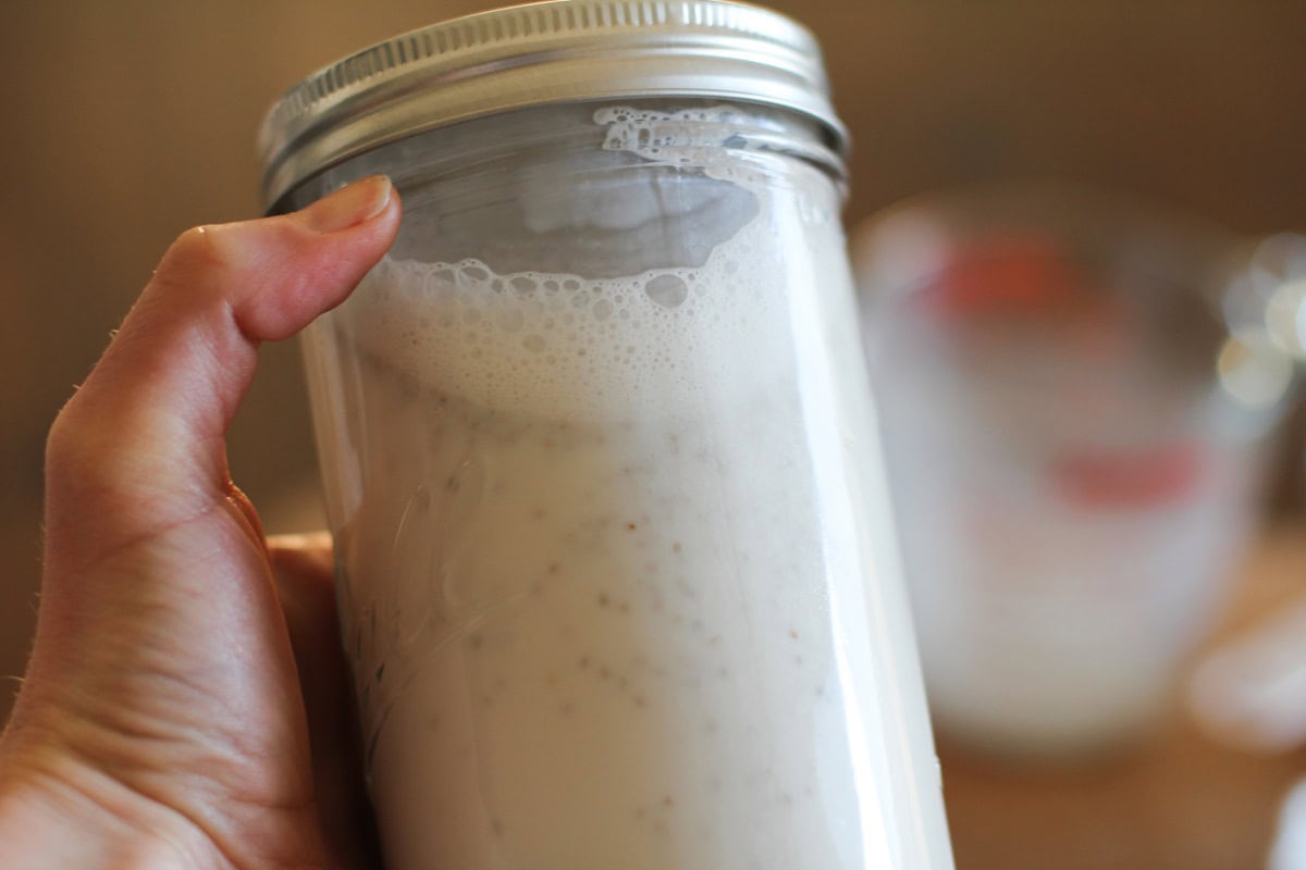 Hand shaking a jar of chia seed pudding.