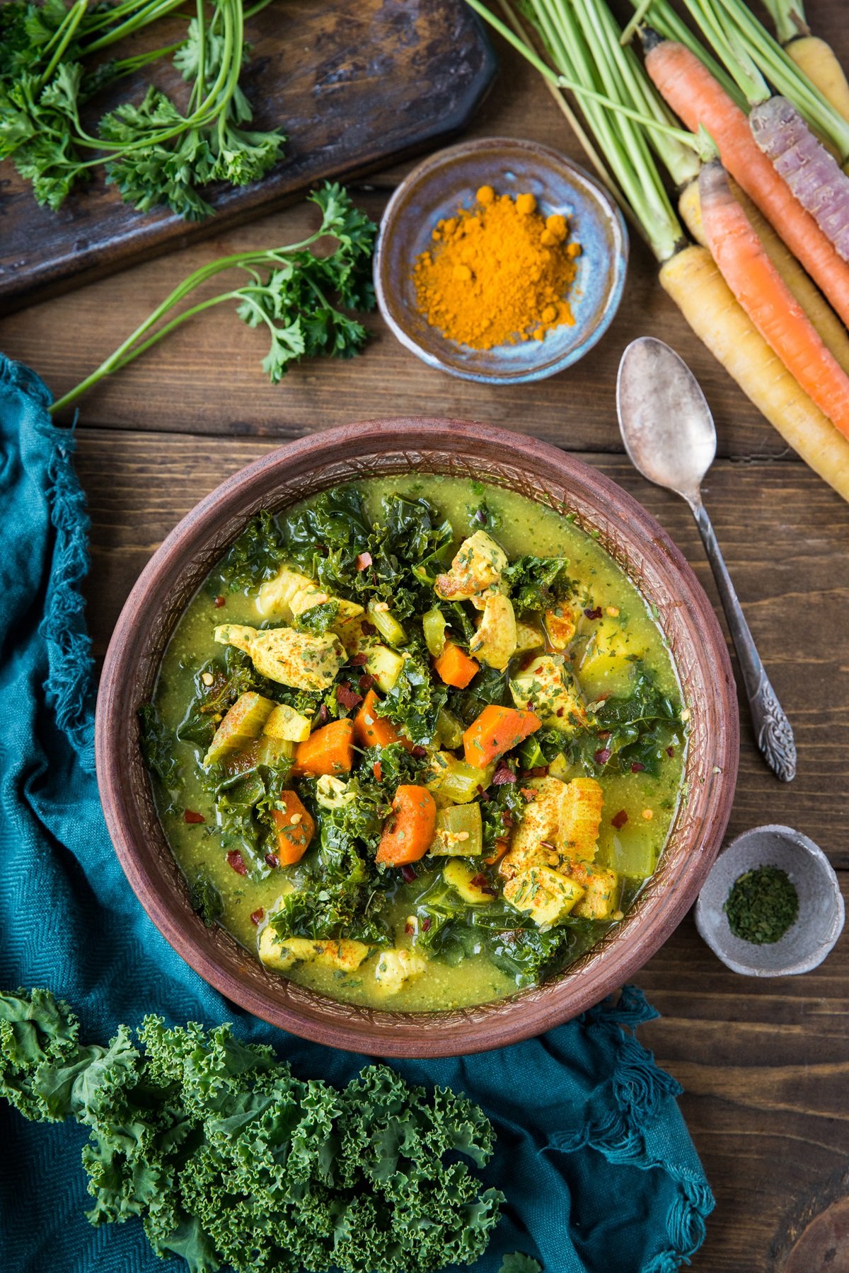 Immunity-Boosting Turmeric Chicken Soup with kale, carrots, parsnips, ginger, and bone broth. A superfood bowl of soup that happens to be paleo, keto, and whole30 | TheRoastedRoot.com #glutenfree