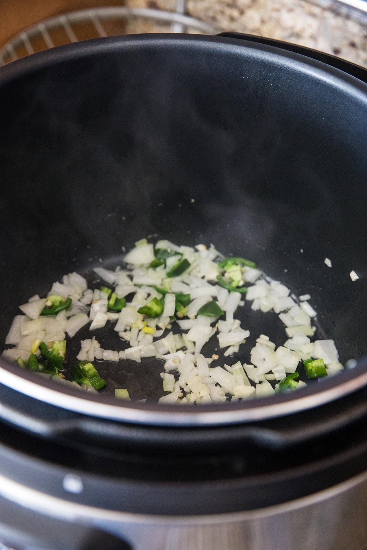 Cooking onion, garlic, and jalapeno in an instant pot for black beans.
