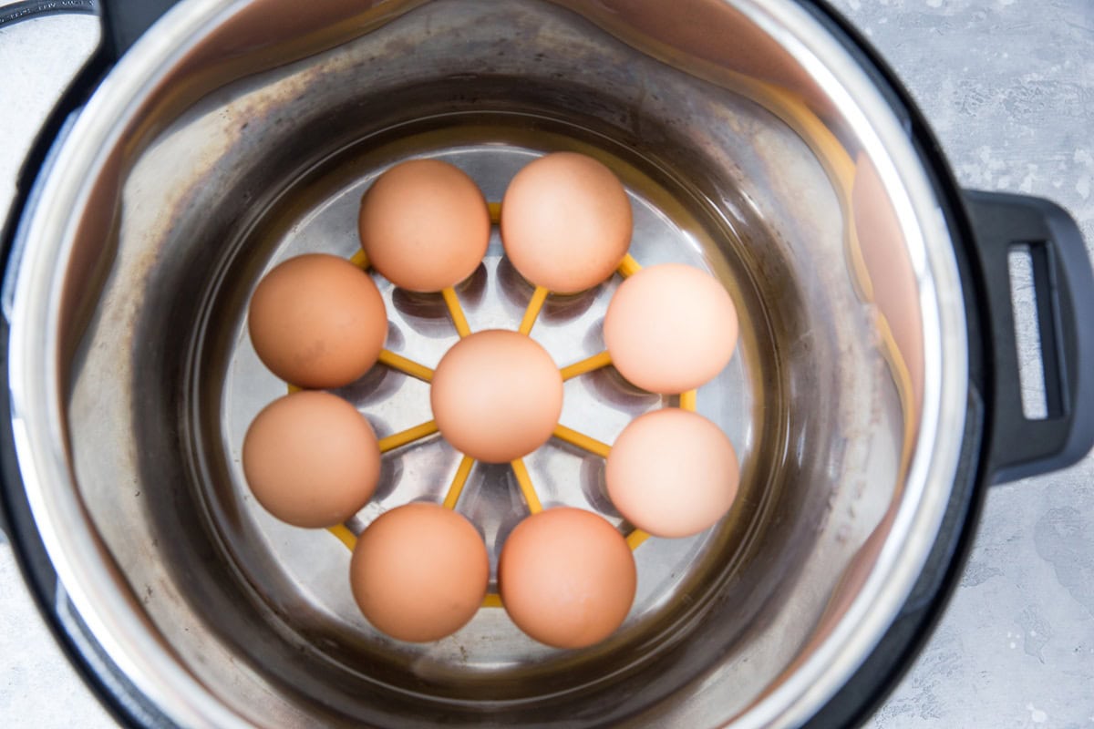 Instant pot with a trivet of eggs inside, ready to cook for hard boiled eggs.