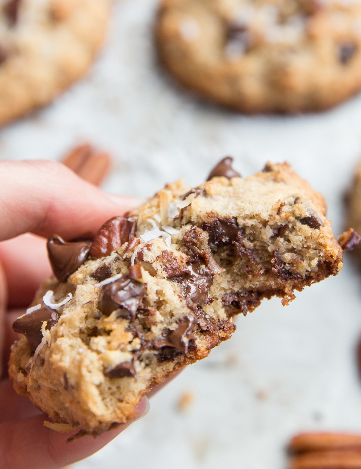 Keto Cowboy Cookies - grain-free, sugar-free keto chocolate chip cookies with pecans, shredded coconut, and more! This low-carb dessert recipe is insanely gooey and delicious!