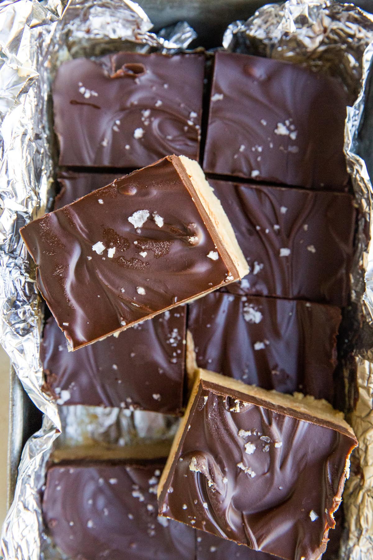 No Bake Chocolate Peanut Butter Bars in a loaf pan, cut into individual squares.