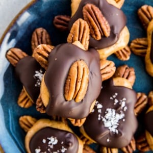 Blue plate full of pecan turtles. Sugar-free pecan turtle candy.