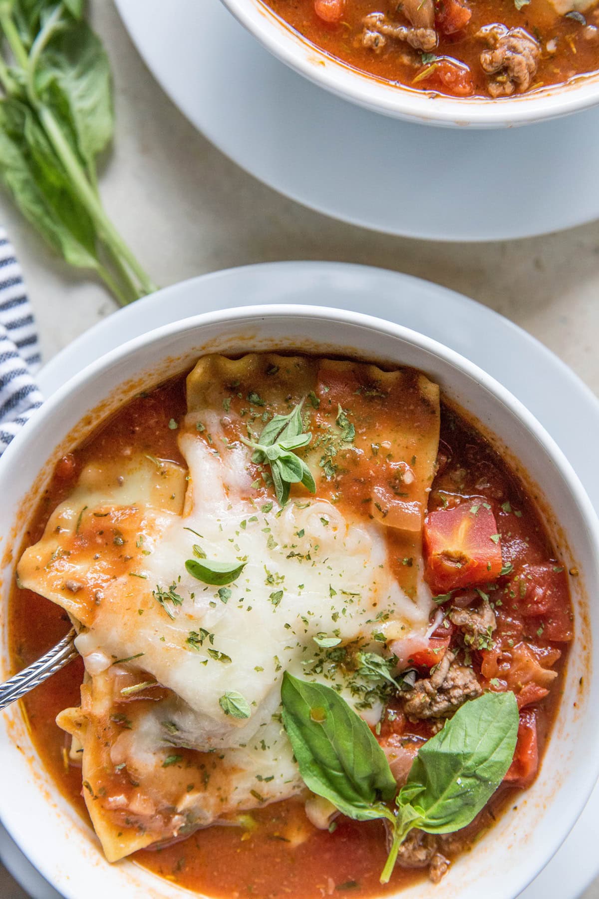 close up photo of spoon lifting up the pasta and cheese in lasagna soup