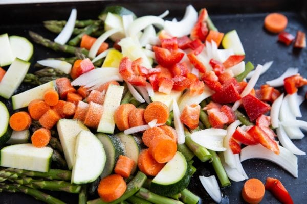 Vegetables on a sheet pan with oil and seasonings.