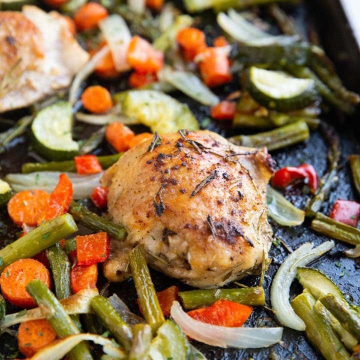 Sheet pan with roasted vegetables and chicken thighs.