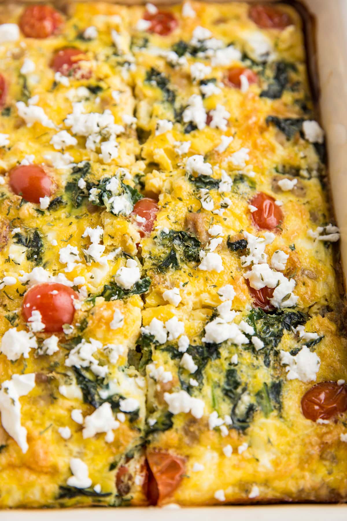 Sliced breakfast casserole in a casserole dish fresh out of the oven and ready to serve.