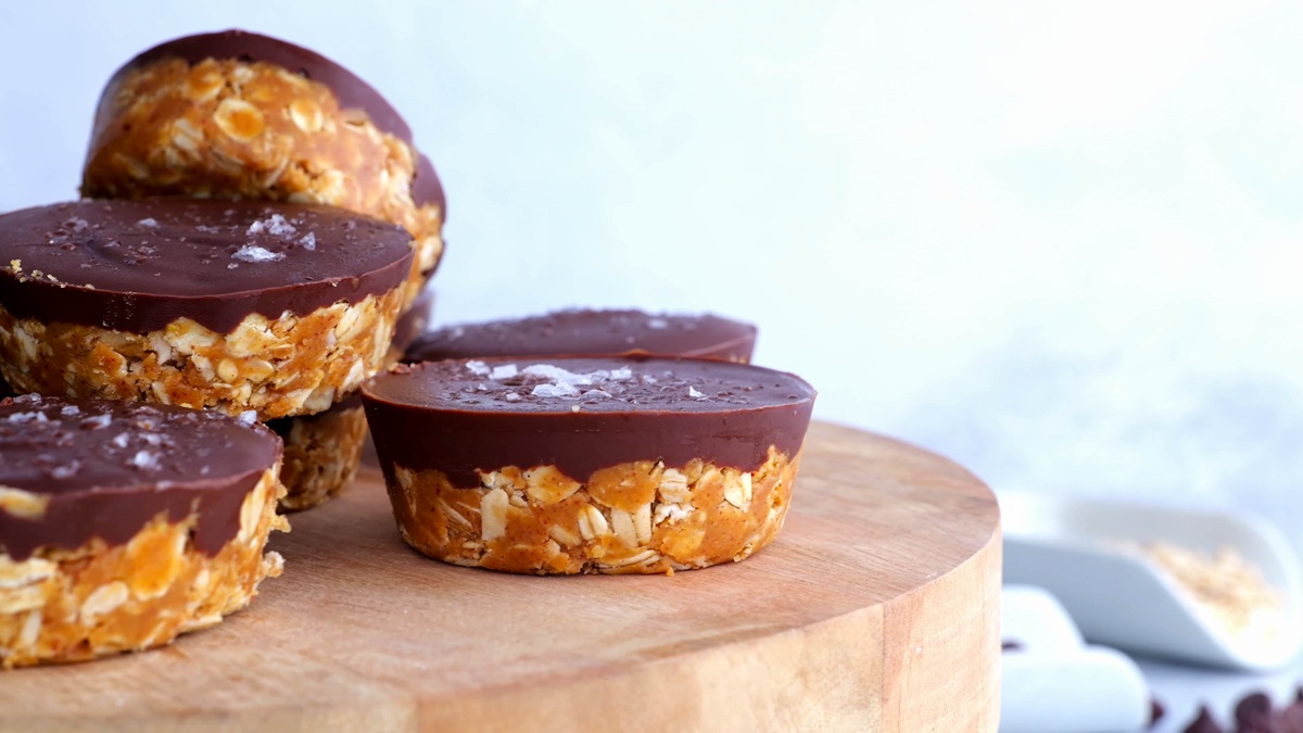 Hand holding a peanut butter cup, ready to eat.