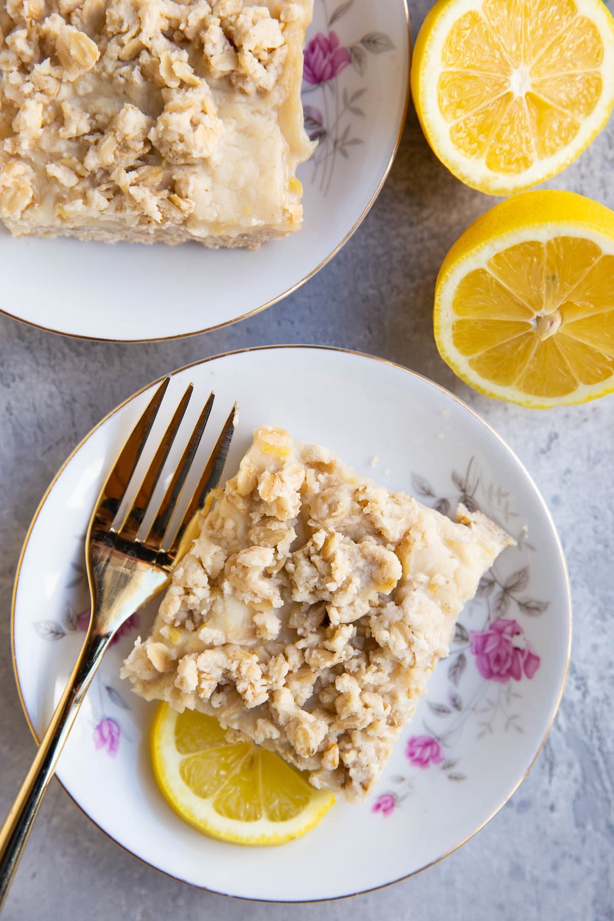 Two plates with slices of lemon crumb bars, ready to eat.