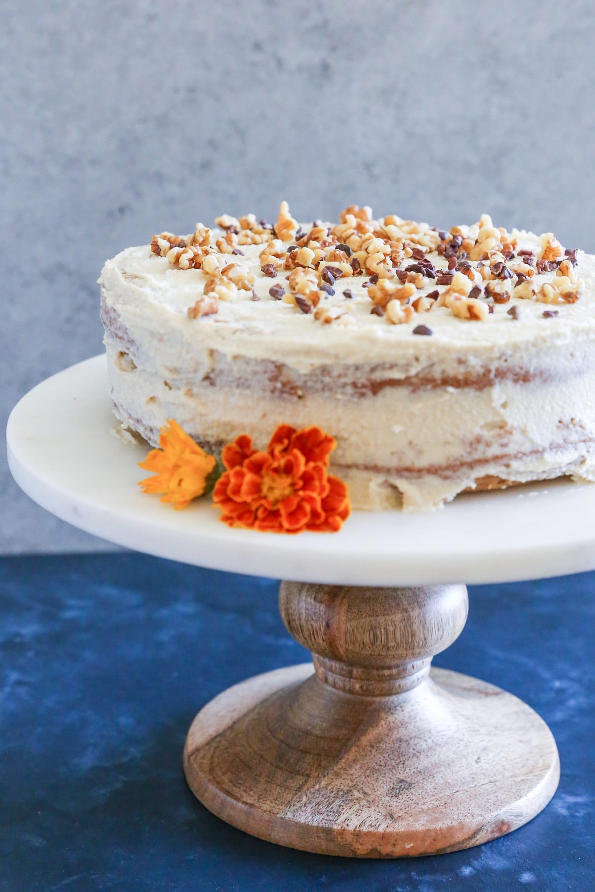 Whole carrot cake on a cake stand.