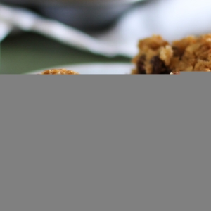 White plate with a paleo morning glory muffin sliced in half to show the inside.