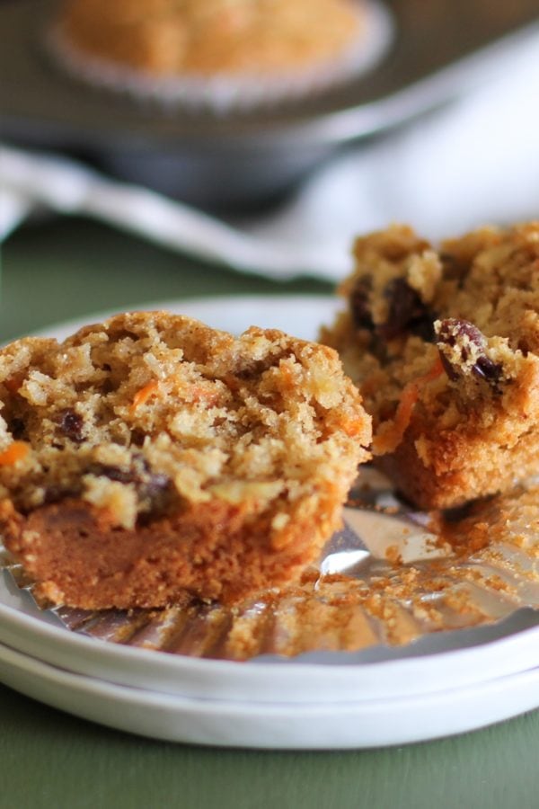 White plate with a paleo morning glory muffin sliced in half to show the inside.