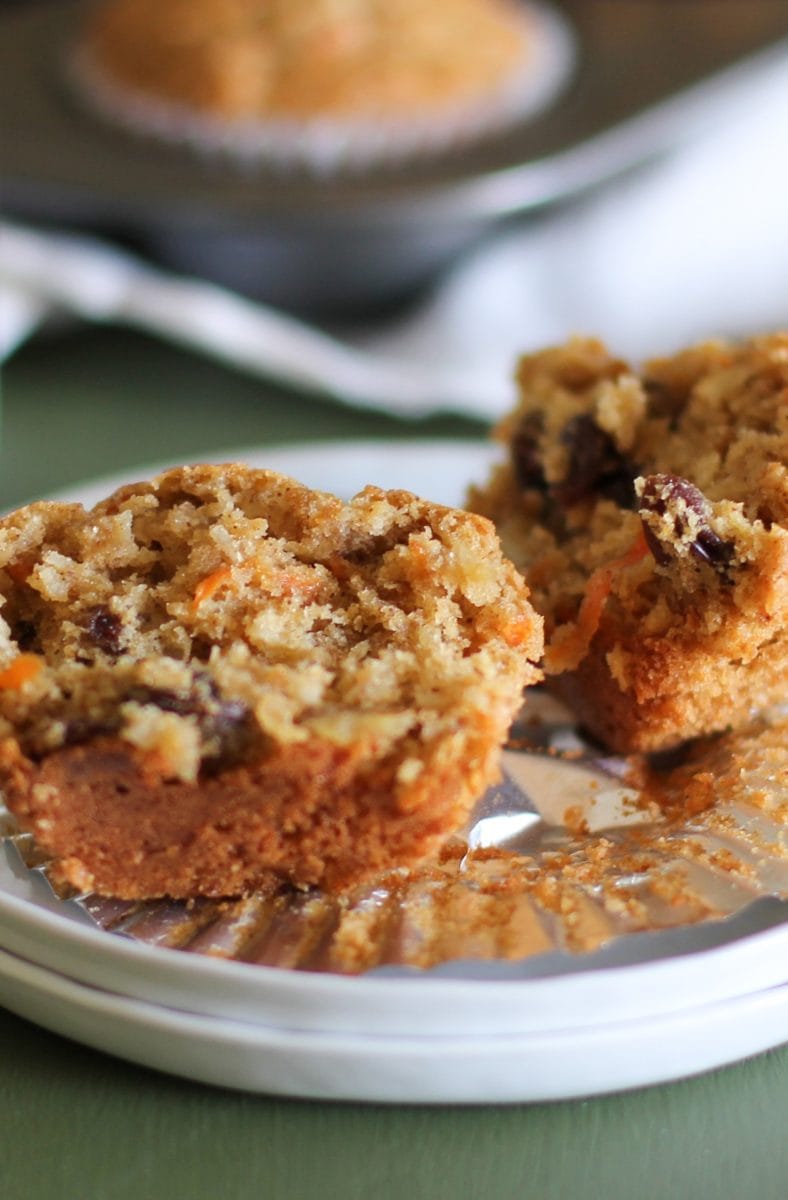 White plate with a paleo morning glory muffin sliced in half to show the inside.