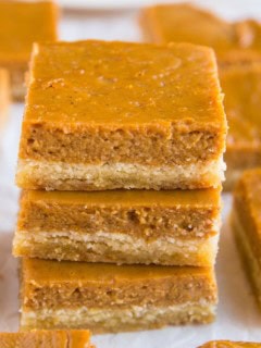 Stack of pumpkin pie bars on top of each other.