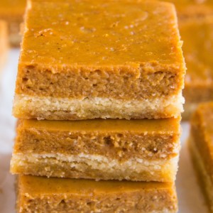 Stack of pumpkin pie bars on top of each other.