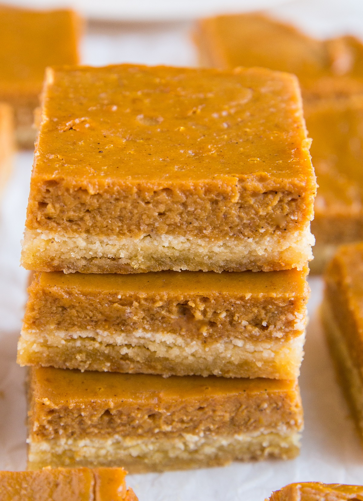 Stack of pumpkin pie bars on top of each other.