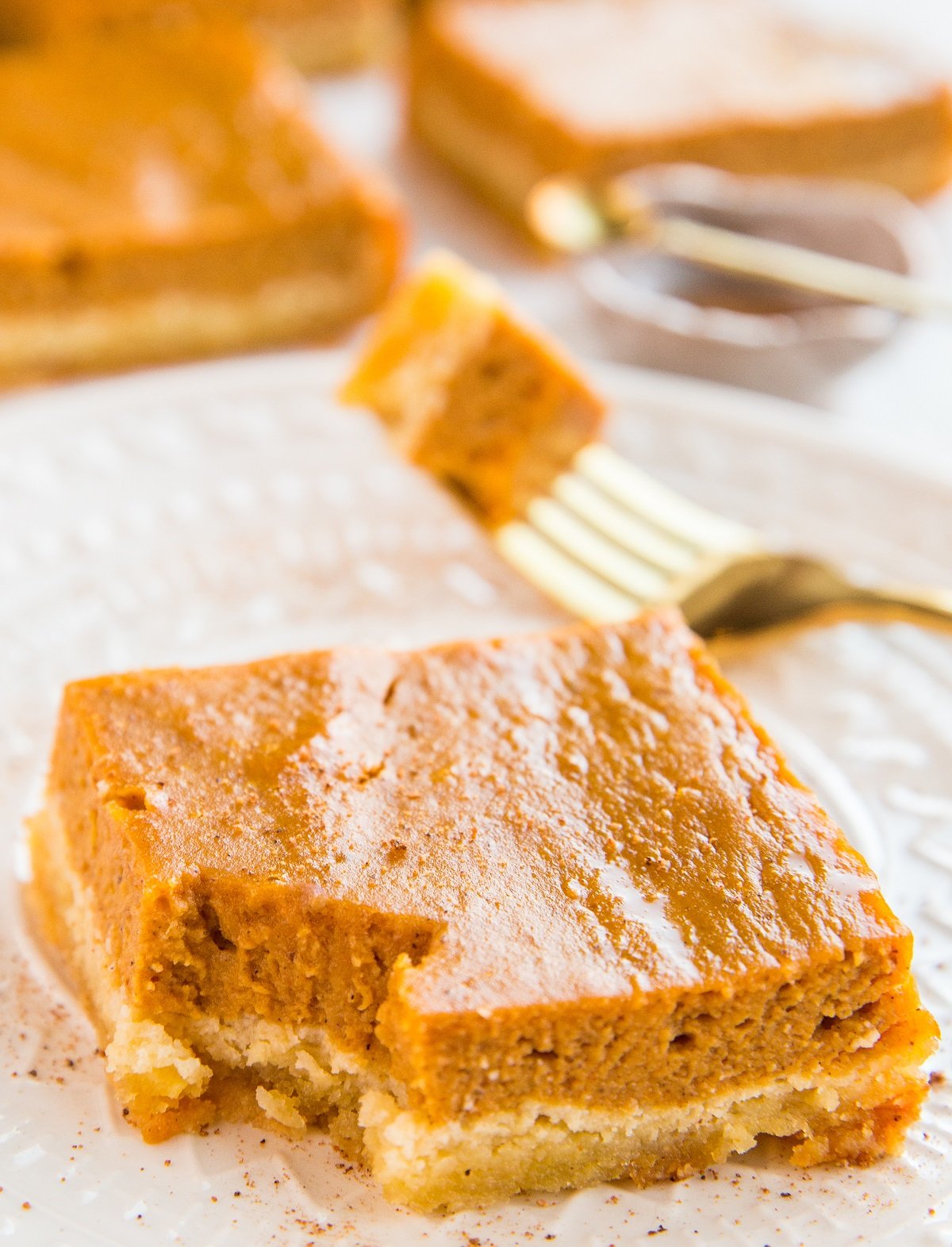 Close up pumpkin pie bar with a bite taken out.