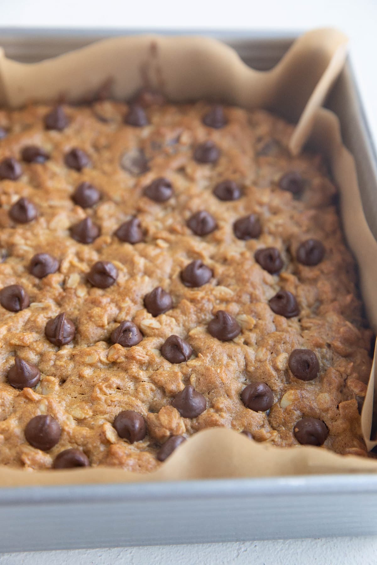 Finished peanut butter oatmeal cookie bars in a square baking pan.