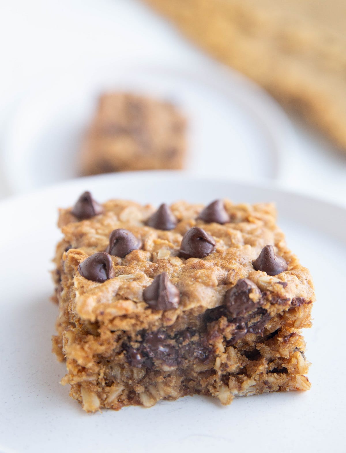 White plate of a square of cookie bar.