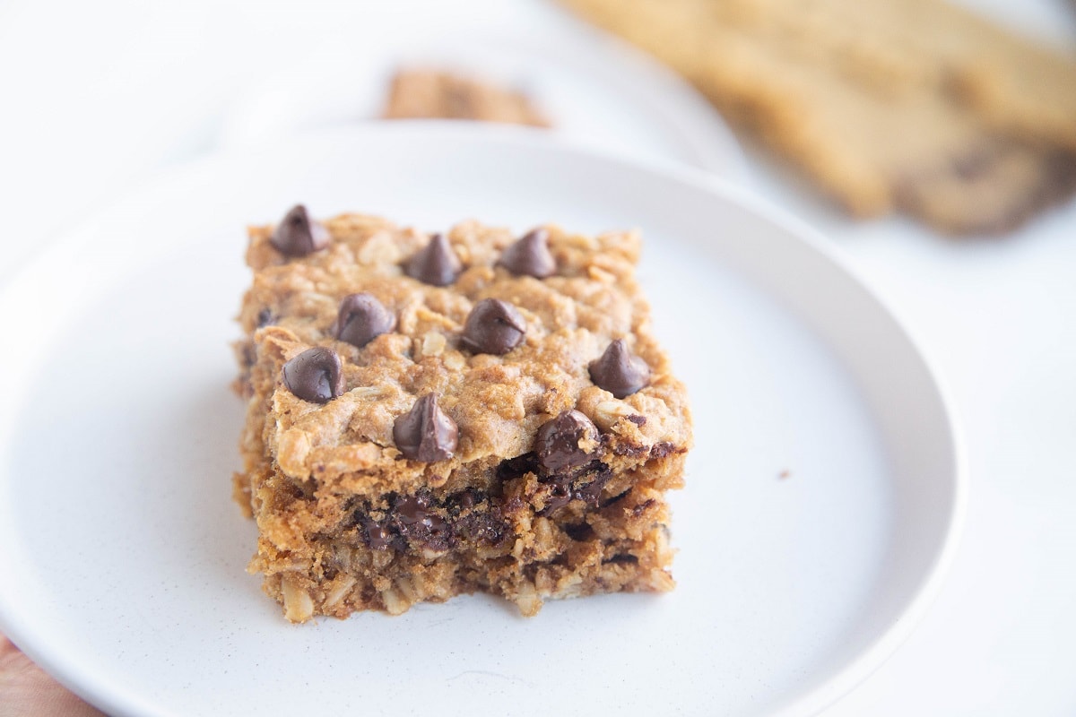 White plate with a single serving of peanut butter cookie bar.