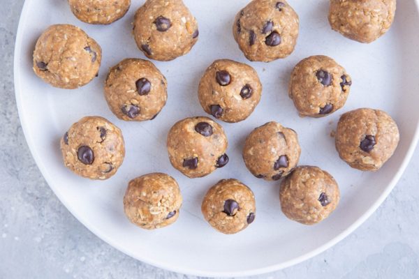 protein balls on a white plate, ready to eat.