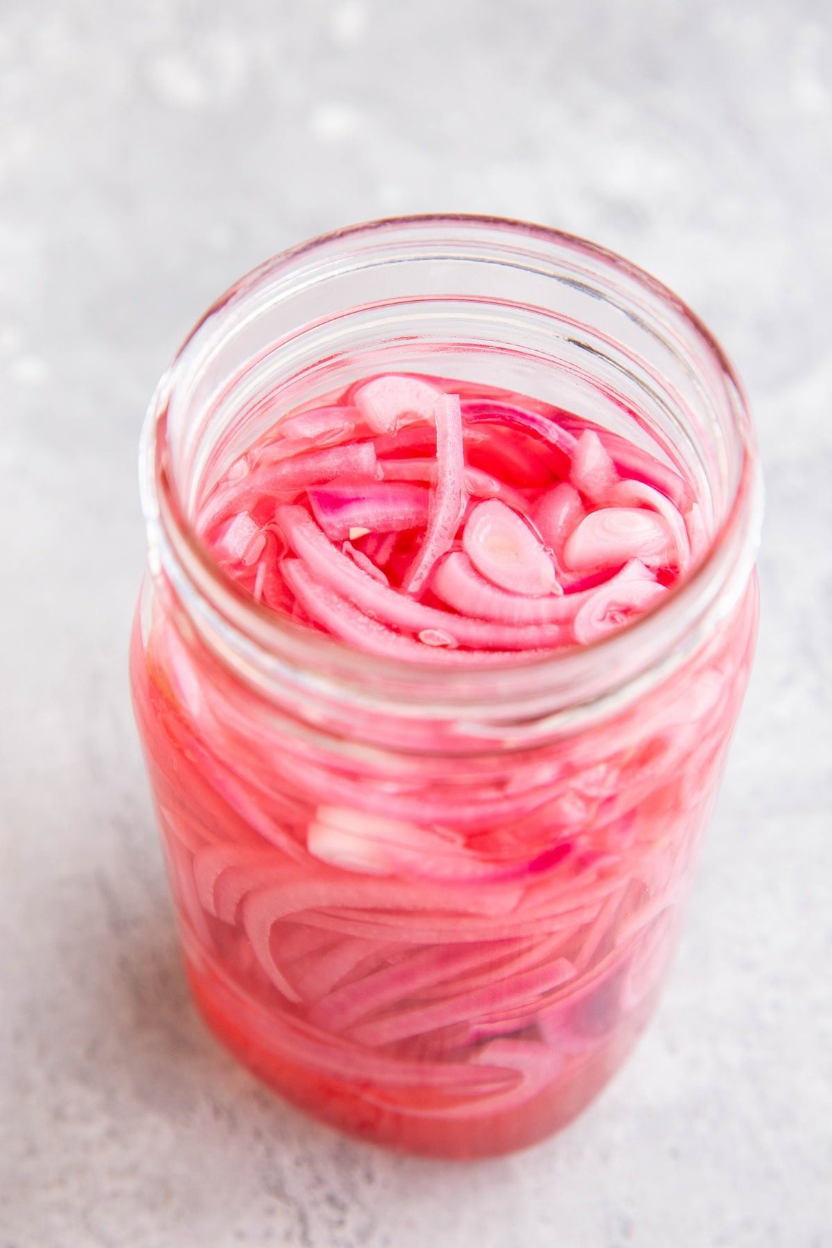 Big 32-ounce jar full of homemade quick pickled red onions.