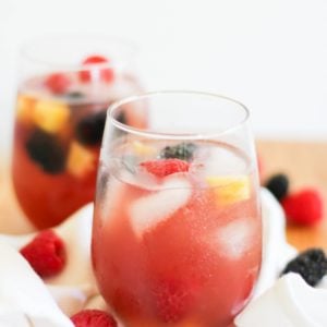 Pineapple Rosé Sangria in a glass with fresh fruit and a white napkin