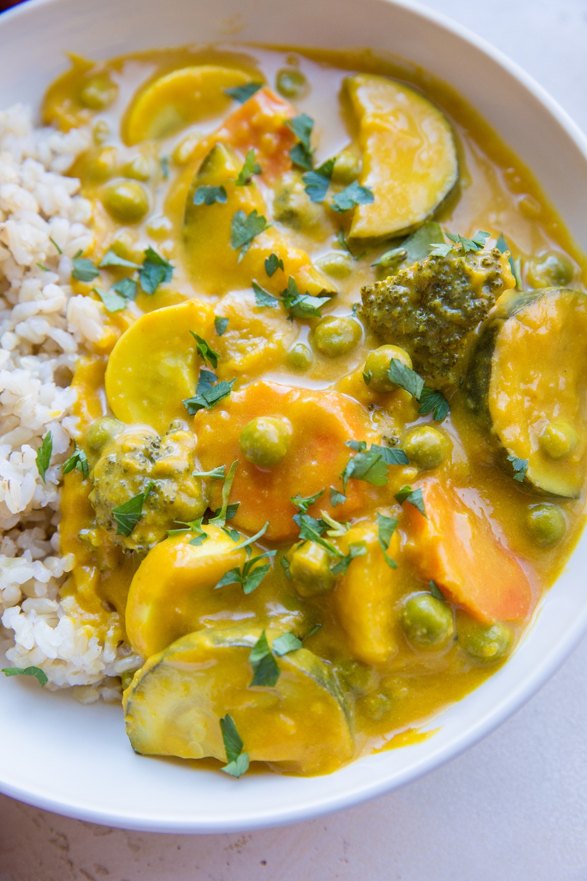 Vegan Pumpkin Curry in a white bowl. Close up to see all the vegetables.