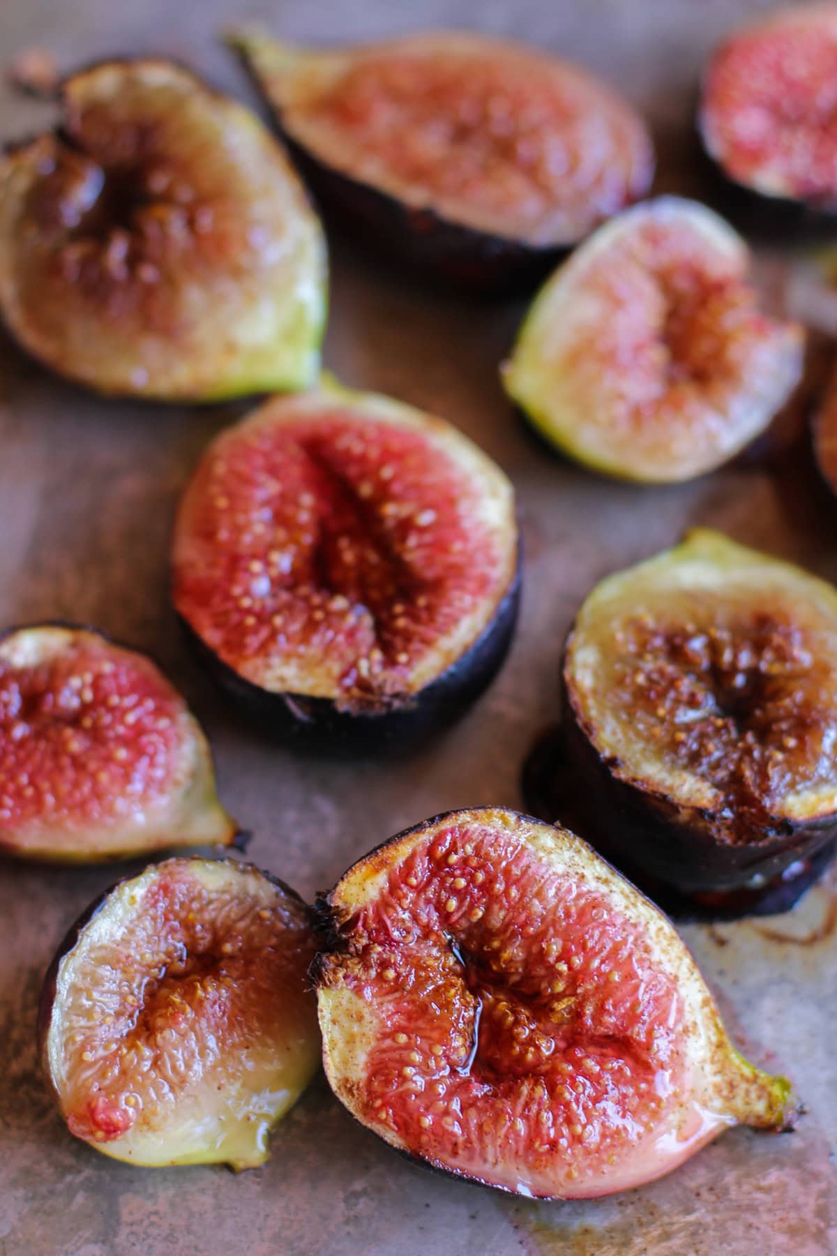 Sheet pan of roasted figs drizzled in pure maple syrup and sprinkled with ground cinnamon fresh out of the oven and ready to serve.