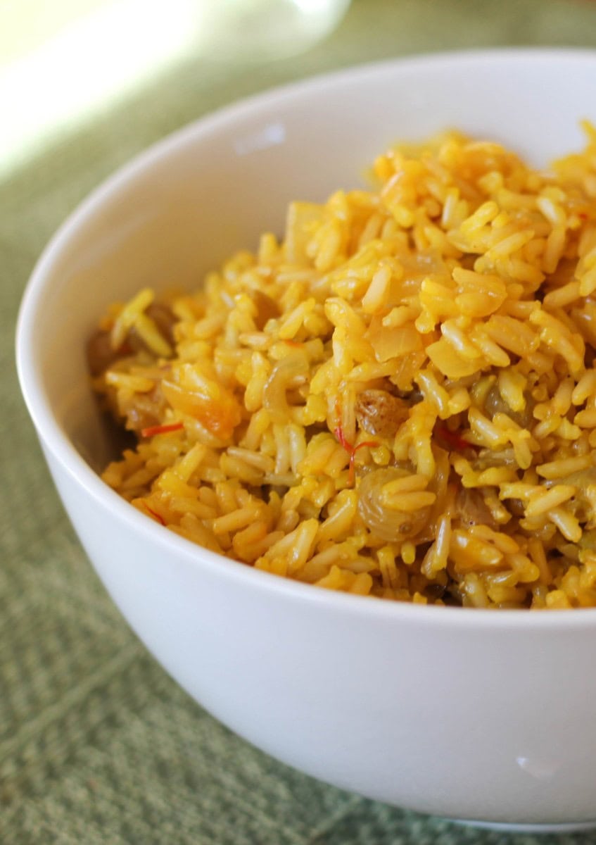 Big bowl full of saffron rice, ready to serve with a main dish.