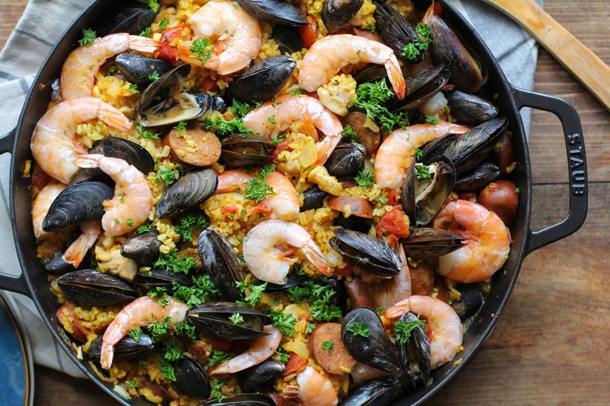 Seafood Paella with chicken, sausage, shrimp, and mussels - a delicious tapas recipe to serve to guests