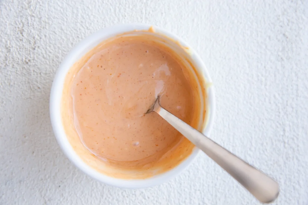 Spicy mayo sauce mixed up in a small bowl to use as dipping sauce or drizzling sauce for air fryer salmon.