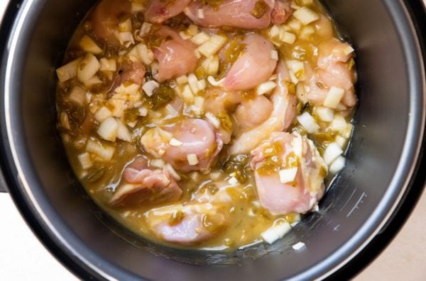 Ingredients for salsa verde chicken stirred up in an instant pot.