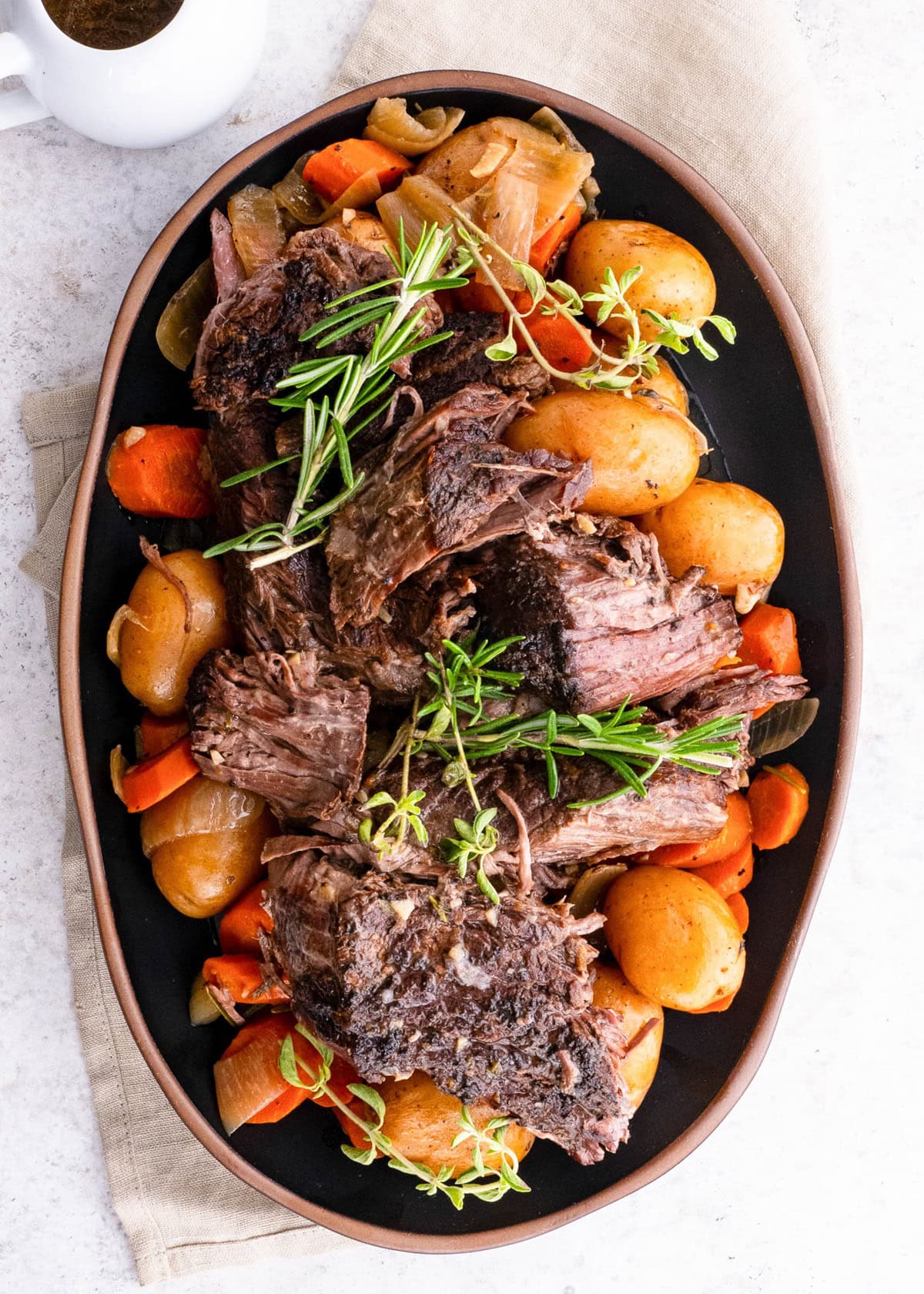 Finished pot roast in a slow cooker, ready to serve.