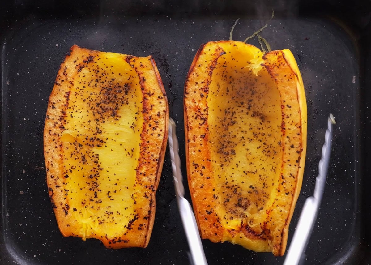 Spaghetti squash halves on a baking dish, fresh out of the oven.