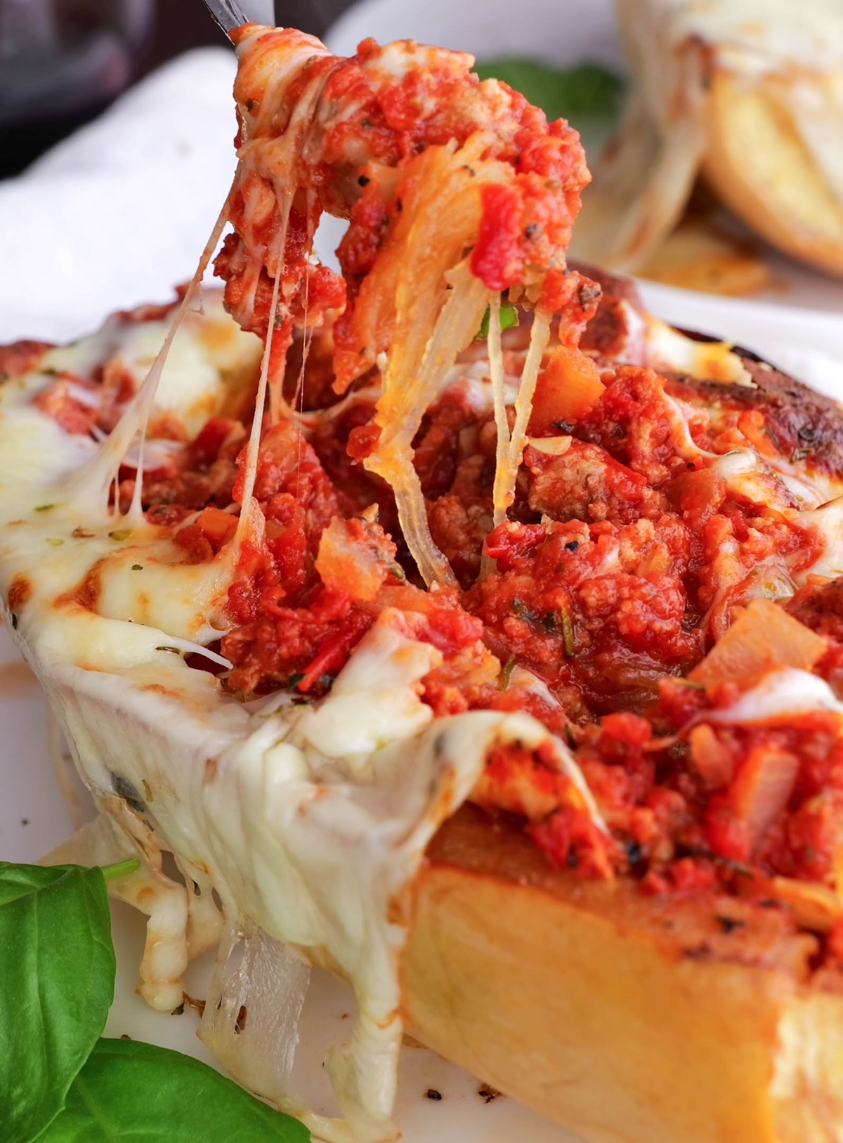 Close up on stuffed spaghetti squash with a fork taking a bite out.