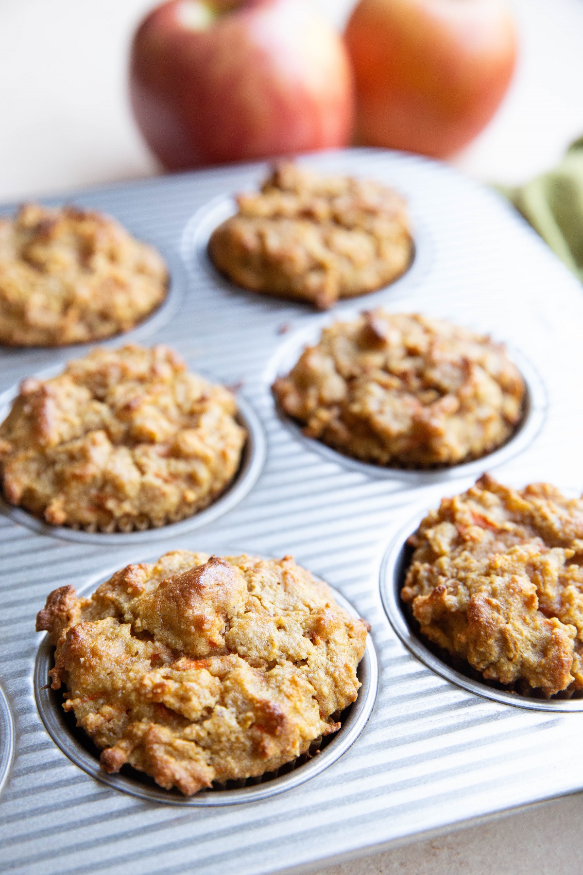 Muffin tray full of spiced apple carrot muffins, fresh out of the oven.