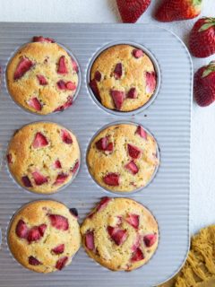 Muffin tray with strawberry muffins, fresh out of the oven.