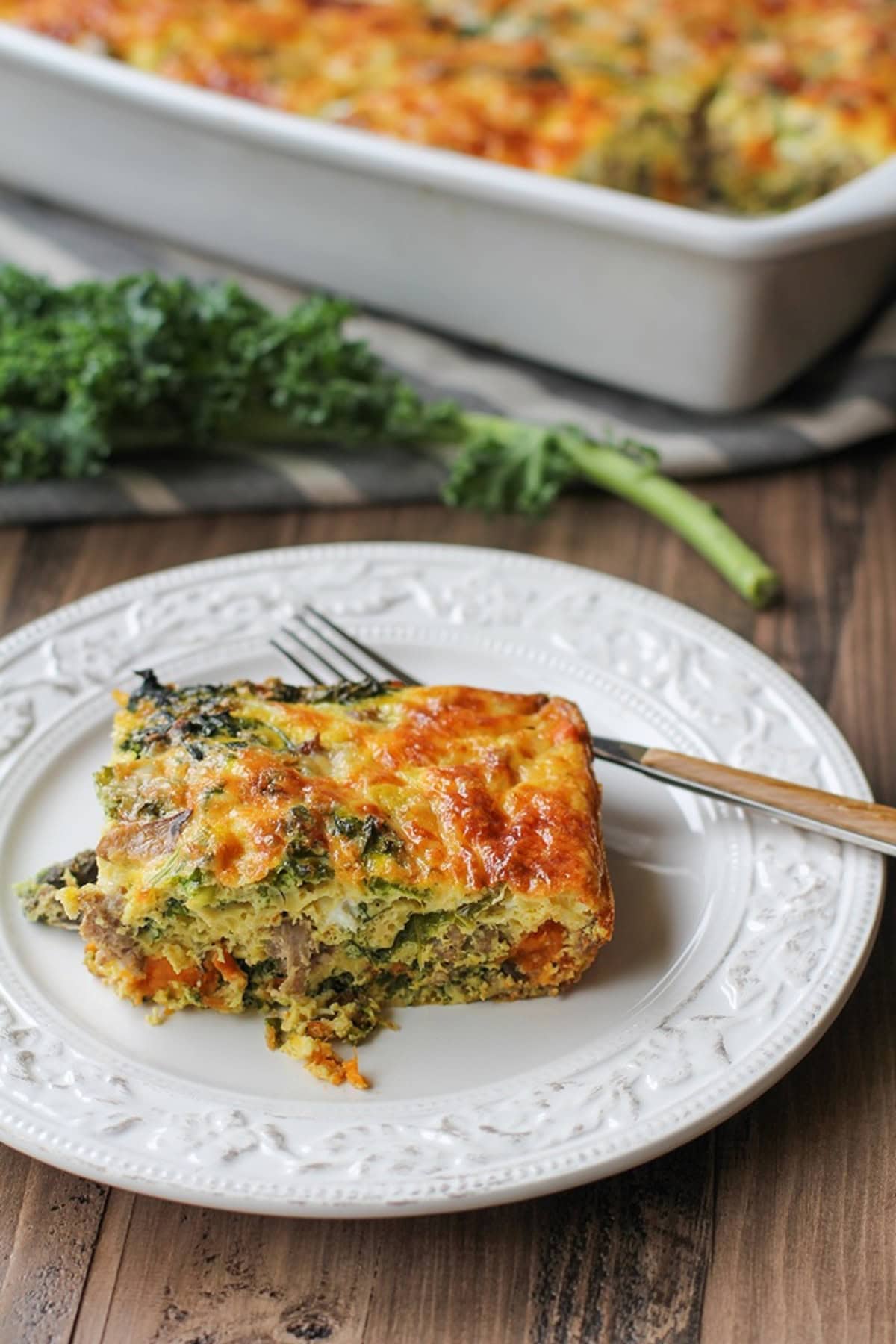 Slice of Sweet Potato, Sausage, Kale Breakfast Casserole on a plate