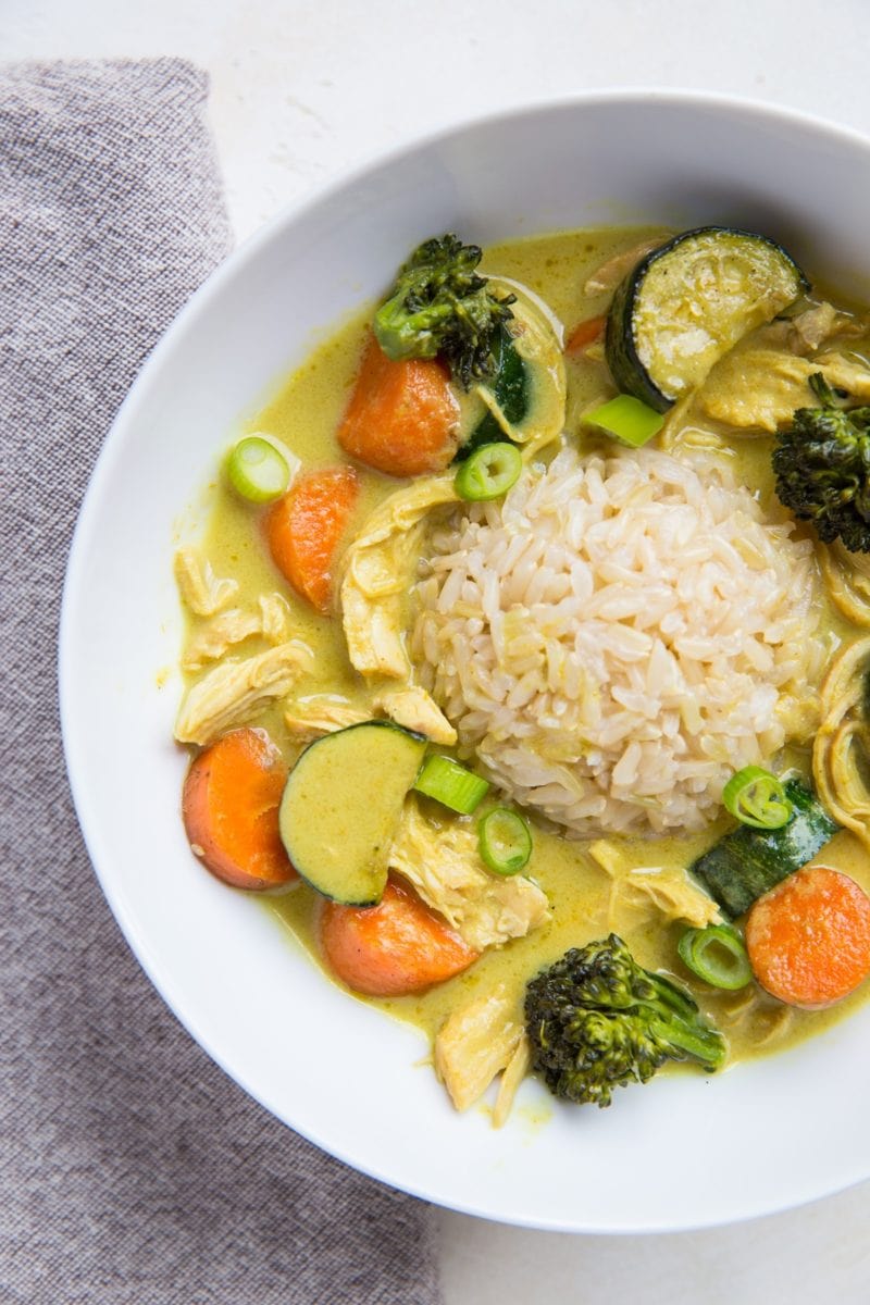 Big bowl of curry for one! Chicken yellow curry with vegetables and brown rice in a large bowl.