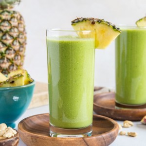 Two glasses of pineapple green protein smoothie