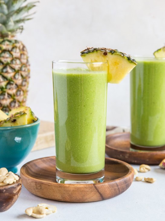 Two glasses of pineapple green protein smoothie