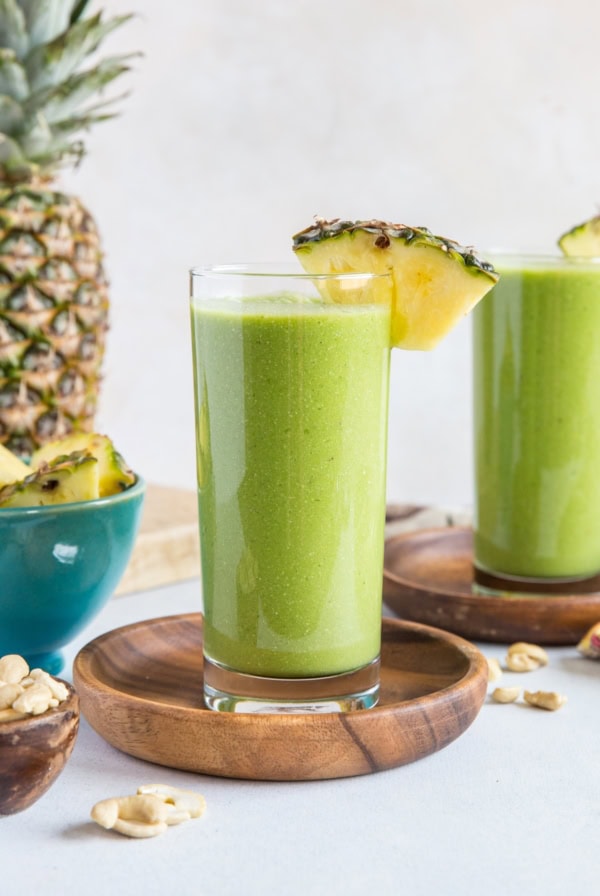 Two glasses of pineapple green protein smoothie