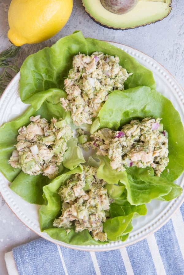 Tuna Lettuce Wraps on a white plate with a blue stripe napkin to the side. Ready to eat.