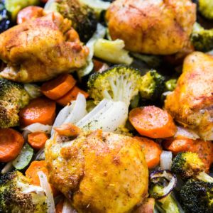 Turmeric Chicken Sheet Pan Dinner with vegetables and seasonings.