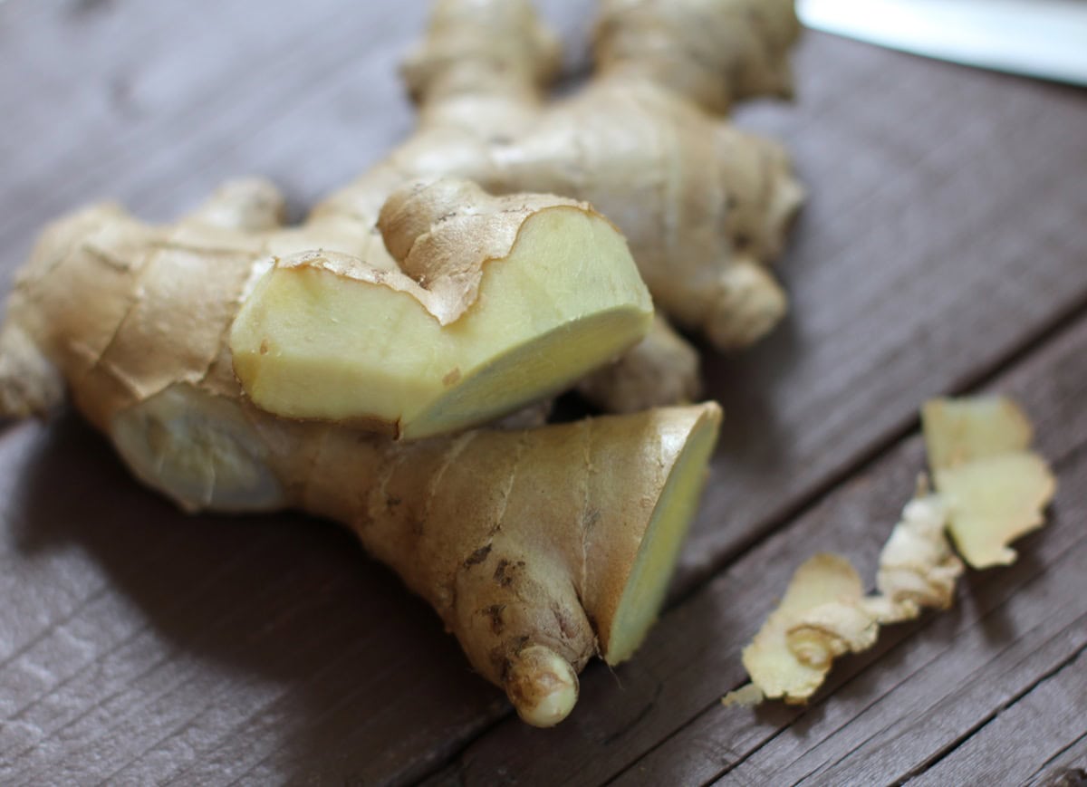 Fresh ginger peeled on a background