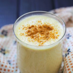 Glass of turmeric lassi with a napkin