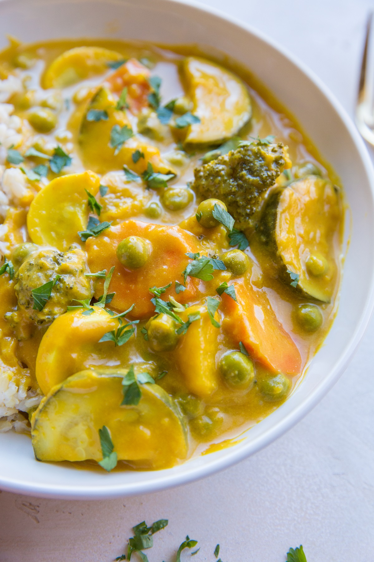 Close up pumpkin curry with vegetables in a white bowl