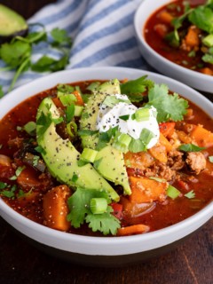 Two bowls of paleo turkey chili with avocado on top. Ready to eat