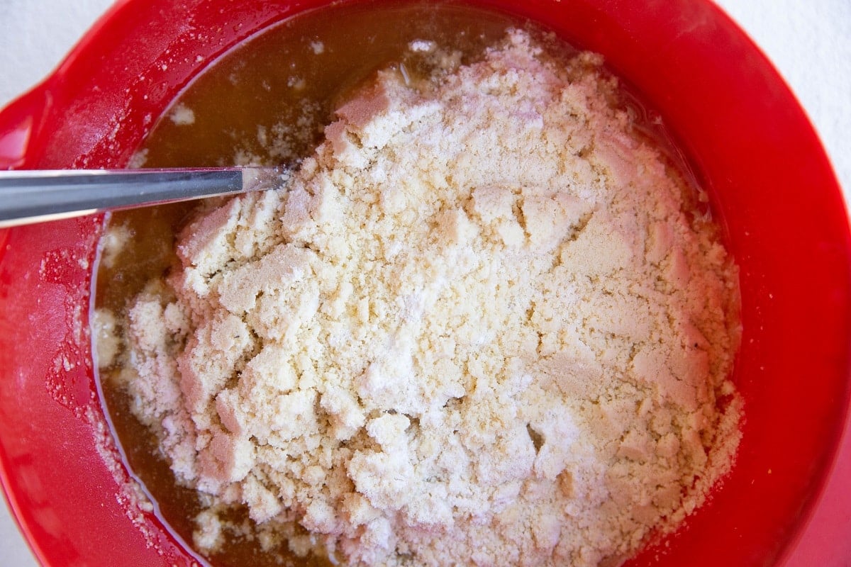 Wet ingredients and dry ingredients in a mixing bowl.